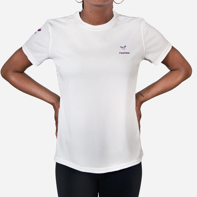 woman wearing white performance shirt with fearless logo
