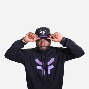 man wearing black fearless logo hoodie and hat