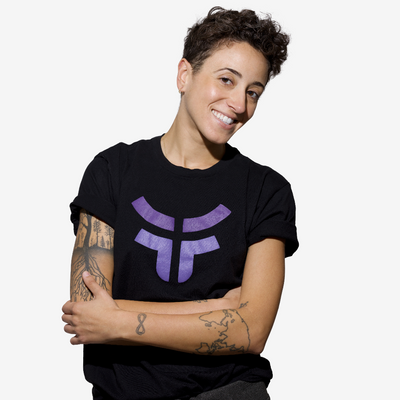 woman smiling wearing black unisex fearless logo tshirt