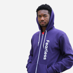 man wearing purple fearless zip up with the hood up